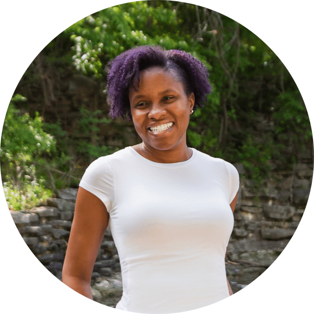 Outdoor Portrait of Merissa Merissa standing outdoors, smiling in casual wear, reflecting her approachable and supportive coaching style.